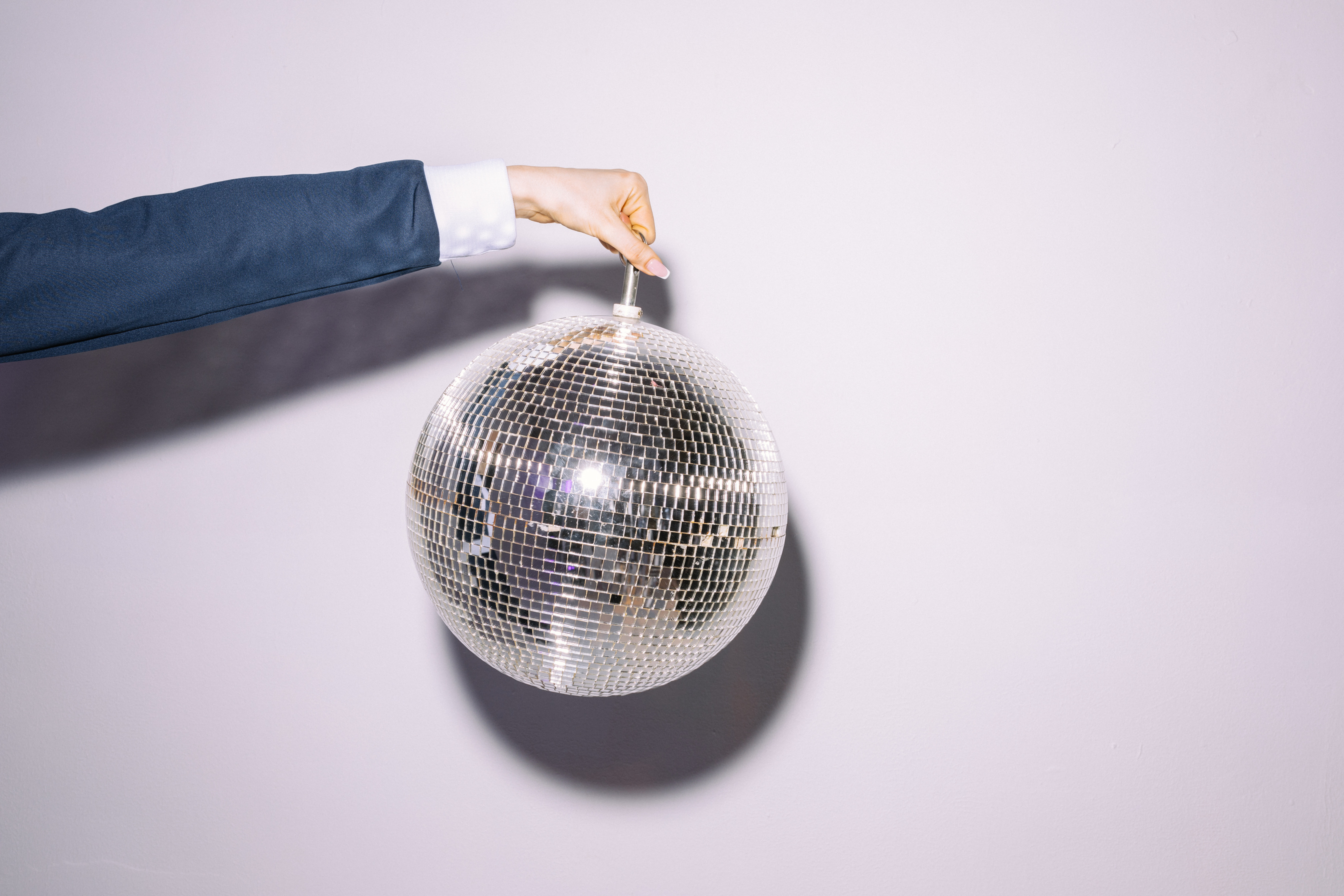 Photograph of a Person Holding a Disco Ball